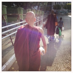 Monks walking in lanes of traffic outside Sule. www.garygeboyphotography.com